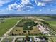 Expansive aerial view showcasing the property's land featuring a house, trees, and surrounding areas at 4501 Detour Rd, Haines City, FL 33844