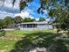 Spacious backyard with mature trees and a screened-in pool area at 4501 Detour Rd, Haines City, FL 33844