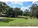 Lush backyard with mature trees and ample green space, perfect for outdoor activities at 4501 Detour Rd, Haines City, FL 33844