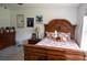 Charming bedroom with wood bed frame, dresser, and natural light at 4501 Detour Rd, Haines City, FL 33844