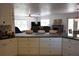 Open-concept kitchen with white cabinetry, granite countertops, and a seamless view into the living area at 4501 Detour Rd, Haines City, FL 33844