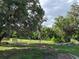 View of lush, partially cleared land with mature trees and an old wooden fence at 4501 Detour Rd, Haines City, FL 33844