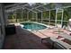 Relaxing screened in pool with a deck and seating area at 4501 Detour Rd, Haines City, FL 33844