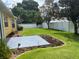 Well-kept backyard featuring a concrete patio, mulch beds and a white fence offering privacy at 4622 Ne 15Th St, Ocala, FL 34470