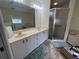 Well-lit primary bathroom with a double vanity, bathtub, glass shower, and neutral tones at 4622 Ne 15Th St, Ocala, FL 34470