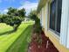 Charming side yard with blooming flowers, well-kept landscaping, and a view of the neighborhood at 4622 Ne 15Th St, Ocala, FL 34470