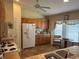 Bright kitchen with ample cabinet space, white refrigerator, ceiling fan, and a cozy breakfast nook at 4622 Ne 15Th St, Ocala, FL 34470