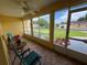 Relaxing screened lanai with a ceiling fan and views of the manicured front yard and neighborhood at 4622 Ne 15Th St, Ocala, FL 34470