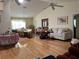 Open-concept living room with hardwood floors, ceiling fans, and a blend of traditional and modern decor at 4622 Ne 15Th St, Ocala, FL 34470