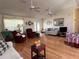Inviting living room with hardwood floors, ceiling fans, and comfortable seating, creating a cozy atmosphere at 4622 Ne 15Th St, Ocala, FL 34470