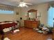 Spacious main bedroom with wood floors, a ceiling fan, and a large dresser with mirror at 4622 Ne 15Th St, Ocala, FL 34470