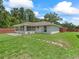 Backyard featuring a sunroom and a fenced-in yard at 4660 Se 142Nd Ln, Summerfield, FL 34491