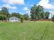 Over 1 acre backyard featuring lush green grass with landscaping providing privacy and a serene atmosphere at 4660 Se 142Nd Ln, Summerfield, FL 34491