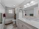 The bathroom features a white vanity with a marble countertop, white sink, and shower/tub combo at 4660 Se 142Nd Ln, Summerfield, FL 34491