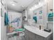 The bathroom features a light gray vanity with white sink and decor with an adorable sea turtle shower curtain at 4660 Se 142Nd Ln, Summerfield, FL 34491