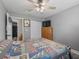 This bedroom features a ceiling fan, window, wood-look flooring, and a large wooden dresser with drawers at 4660 Se 142Nd Ln, Summerfield, FL 34491