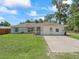 Charming single-story home with a well-manicured lawn and a cozy, welcoming facade at 4660 Se 142Nd Ln, Summerfield, FL 34491