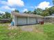 Spacious detached three-car garage providing ample parking and storage space with yard view at 4660 Se 142Nd Ln, Summerfield, FL 34491
