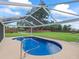Beautiful screened pool with a pristine blue interior and a spacious deck for lounging and entertaining at 4660 Se 142Nd Ln, Summerfield, FL 34491