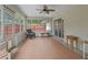 Sunroom featuring tile floors, large windows, and comfortable seating at 4660 Se 142Nd Ln, Summerfield, FL 34491
