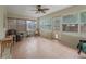 Bright sunroom with tile flooring, multiple windows, and access to backyard at 4660 Se 142Nd Ln, Summerfield, FL 34491