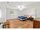 Sunlit bedroom showcasing wood laminate flooring and a ceiling fan at 475 Ne 155Th Pl, Citra, FL 32113