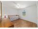 Bright bedroom featuring a large window and wood laminate flooring at 475 Ne 155Th Pl, Citra, FL 32113