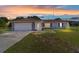 Charming single-story home with a red tile roof, garage, and lovely lawn at 475 Ne 155Th Pl, Citra, FL 32113