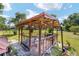 Picturesque backyard gazebo with stone tile flooring and seating for outdoor entertaining at 475 Ne 155Th Pl, Citra, FL 32113