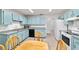 Bright eat-in kitchen featuring light blue cabinets and modern appliances at 475 Ne 155Th Pl, Citra, FL 32113
