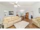 Spacious living room with laminate floors, a ceiling fan, and an open dining area at 475 Ne 155Th Pl, Citra, FL 32113