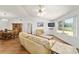 Bright living room with laminate floors, ceiling fan, and a large window providing natural light at 475 Ne 155Th Pl, Citra, FL 32113