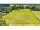 Beautiful lot showcasing a vast field enclosed by a rustic wooden fence and mature trees at 475 Ne 155Th Pl, Citra, FL 32113