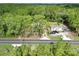 Aerial view of a home with a long driveway and mature tree coverage at 5630 Se 183Rd Avenue Rd, Ocklawaha, FL 32179