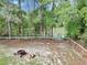 Lakeside backyard with a fire pit, providing a serene outdoor space at 5630 Se 183Rd Avenue Rd, Ocklawaha, FL 32179
