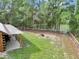 Expansive backyard featuring a lakeside view, fire pit, and covered patio area at 5630 Se 183Rd Avenue Rd, Ocklawaha, FL 32179