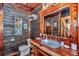 Rustic bathroom featuring wood walls, unique sink, and stylish decor at 5630 Se 183Rd Avenue Rd, Ocklawaha, FL 32179