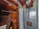 Unique bathroom featuring wood and metal finishes, a shower with a watering can showerhead, and rustic decor at 5630 Se 183Rd Avenue Rd, Ocklawaha, FL 32179