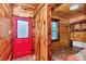 Bedroom with matching wood walls, door and trim, window, and an attached laundry closet at 5630 Se 183Rd Avenue Rd, Ocklawaha, FL 32179