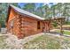 Exterior view of log cabin with a metal roof and covered porch at 5630 Se 183Rd Avenue Rd, Ocklawaha, FL 32179