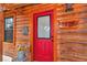 Inviting front door featuring a vibrant red door with glass insert and rustic address plaque at 5630 Se 183Rd Avenue Rd, Ocklawaha, FL 32179