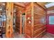 Rustic hallway featuring wood walls and trim, with doors leading to various rooms at 5630 Se 183Rd Avenue Rd, Ocklawaha, FL 32179