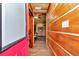 Hallway showcasing natural wood walls and flooring, leading to the home's interior at 5630 Se 183Rd Avenue Rd, Ocklawaha, FL 32179