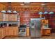 A rustic kitchen featuring stainless steel appliances, wood cabinets, and ample counter space at 5630 Se 183Rd Avenue Rd, Ocklawaha, FL 32179