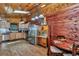 Charming rustic kitchen with wood walls, stainless steel appliances, and a breakfast nook at 5630 Se 183Rd Avenue Rd, Ocklawaha, FL 32179