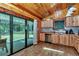 Rustic kitchen featuring wood cabinetry, stainless steel appliances, and a sliding glass door to the outdoors at 5630 Se 183Rd Avenue Rd, Ocklawaha, FL 32179