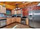 Charming rustic kitchen with wood cabinets, stainless steel appliances, and unique backsplash at 5630 Se 183Rd Avenue Rd, Ocklawaha, FL 32179