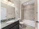 Well-lit bathroom featuring a tub shower, a vanity with a grey countertop, and a mirrored wall at 6299 Sw 90Th St, Ocala, FL 34476