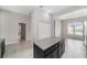 Open-concept kitchen island with dark wood cabinetry, granite countertop, and tiled flooring at 6299 Sw 90Th St, Ocala, FL 34476