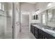 Bright main bathroom with a glass-enclosed shower, dual sinks, and a view into the main bedroom at 6299 Sw 90Th St, Ocala, FL 34476